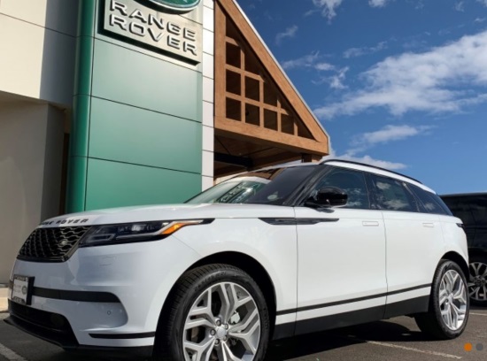 Messner Foundation 6-08-2019 raffle - 2019 Range Rover Velar P250 S - left front with bldg 